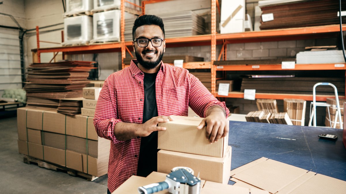 Employee packing cartons in the HSG warehouse